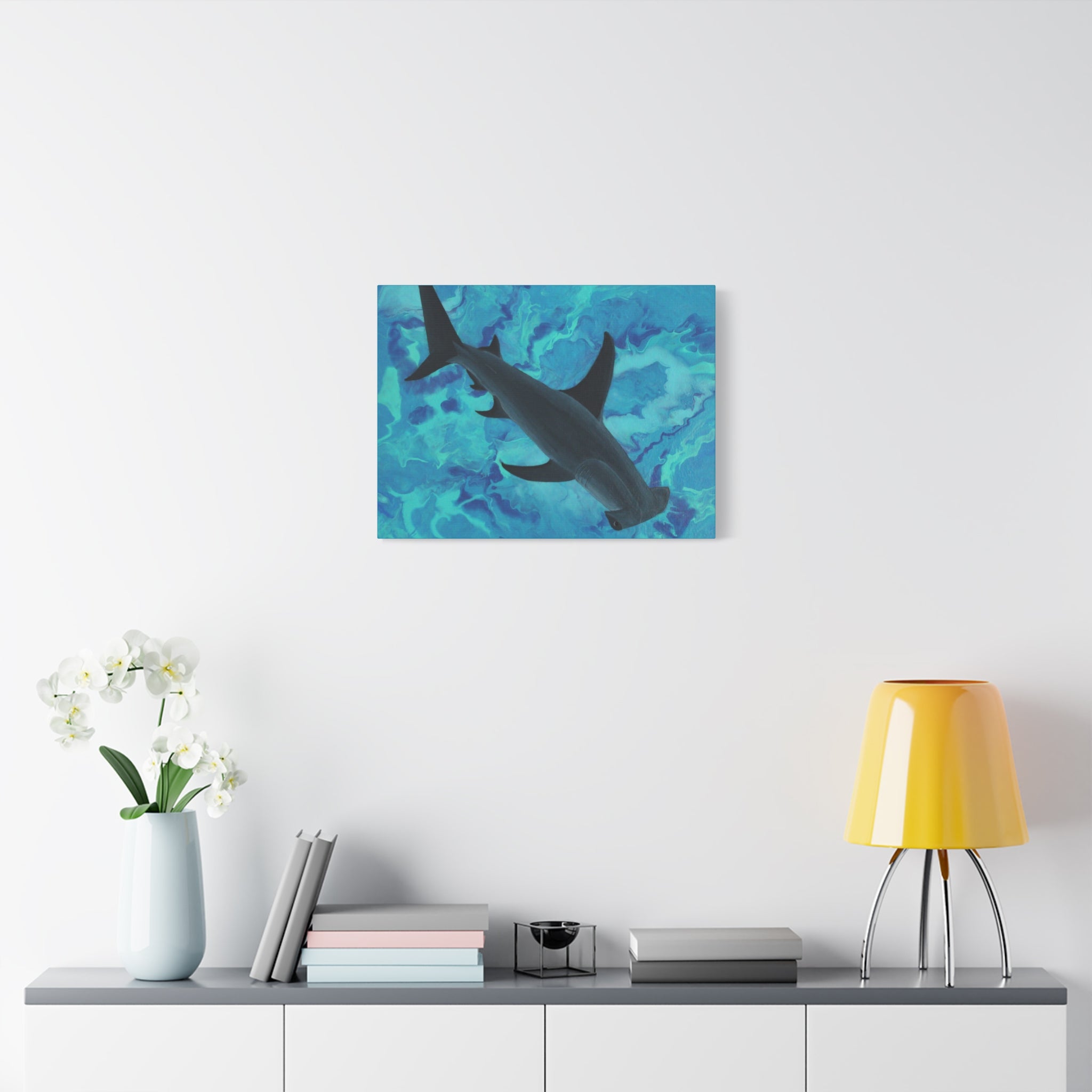 Shark painting on a wall above a shelf with decor items