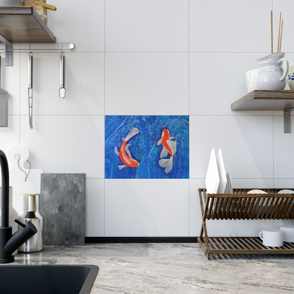 Kitchen interior with a decorative tile featuring two fish on a white tiled wall.