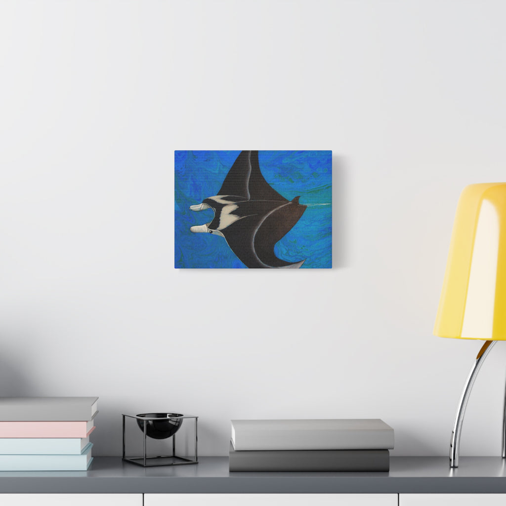 Abstract painting of a manta ray on a wall above a desk with books and a lamp.