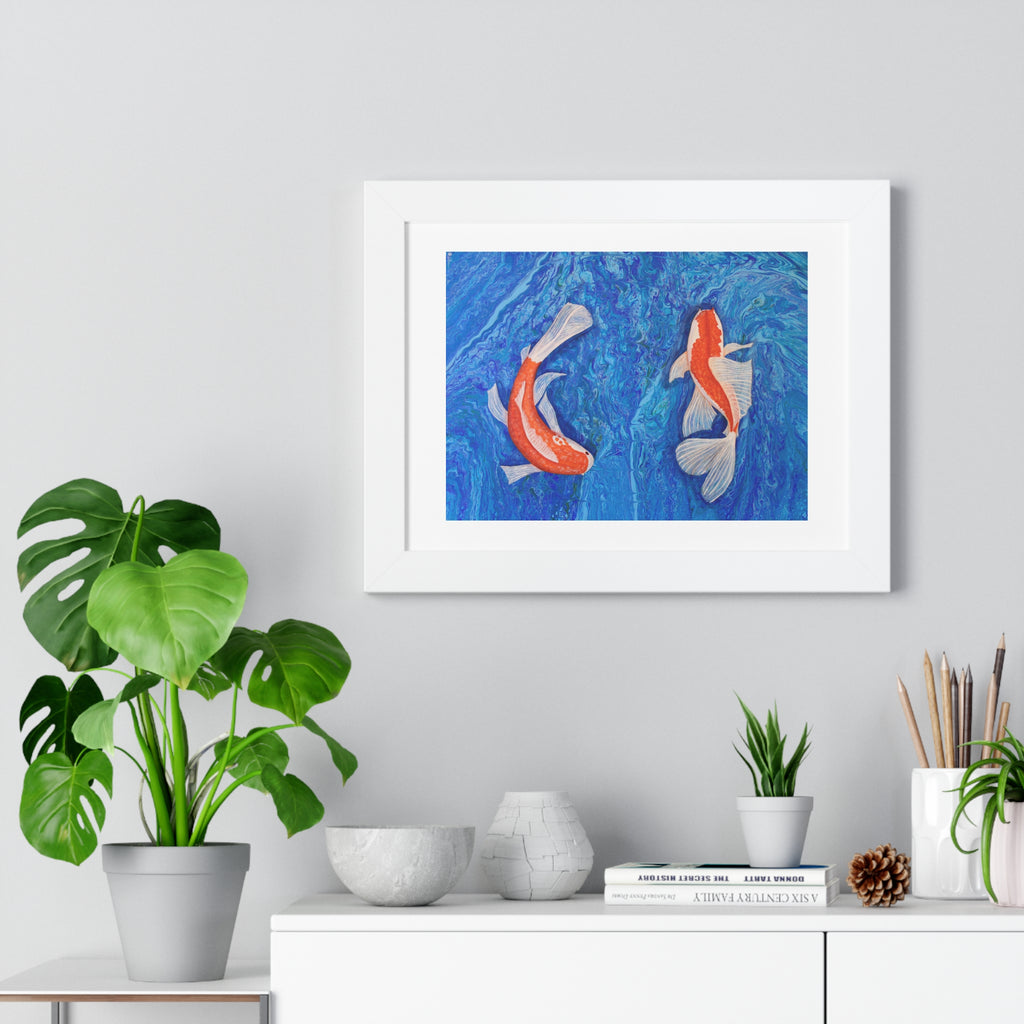 Framed artwork of two koi fish on a blue background, displayed on a wall above a white cabinet with decorative items.