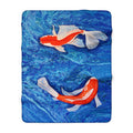 Blanket with two goldfish designs on a blue water background