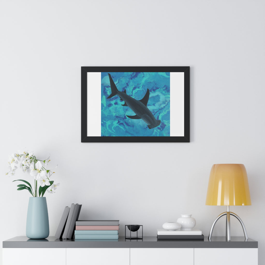 Framed artwork of a shark in water on a wall above a shelf with decor items.