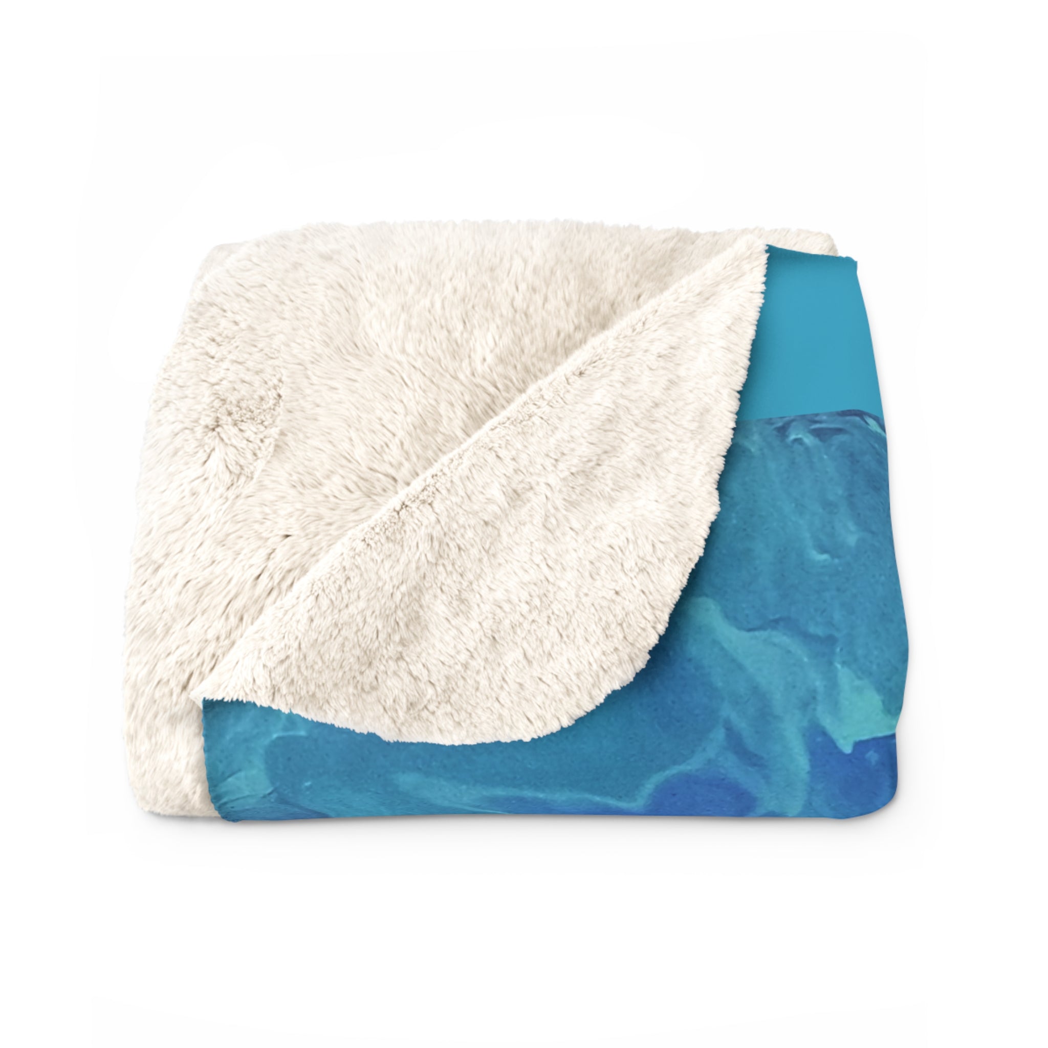 Folded blanket with white sherpa interior and blue exterior on a white background