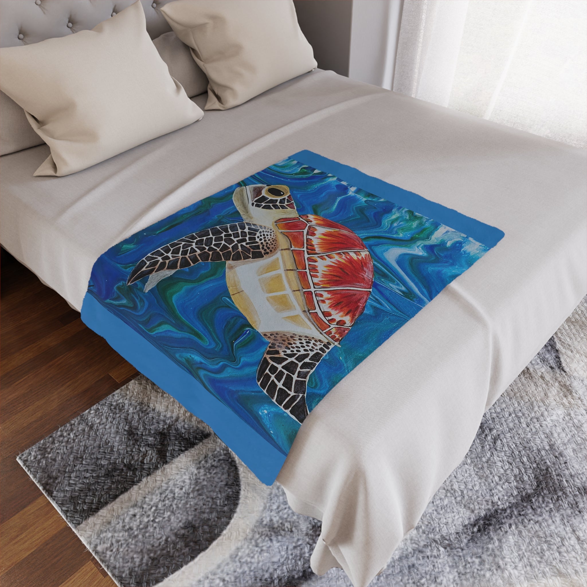 Bed with a colorful turtle design blanket on a wooden floor.