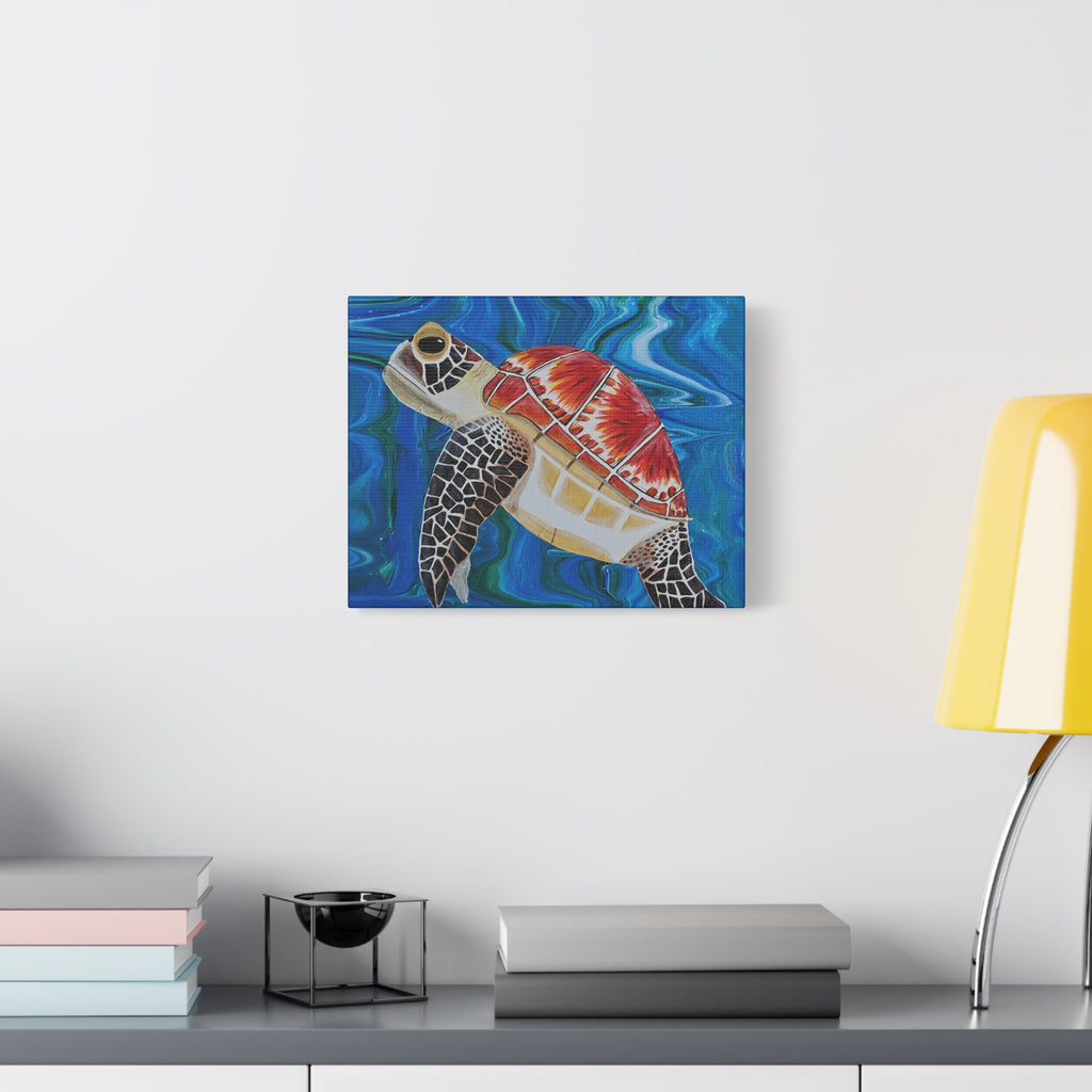 Canvas print of a colorful turtle on a wall above a desk with books and a lamp.