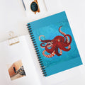 Notebook with a red octopus design on a white surface