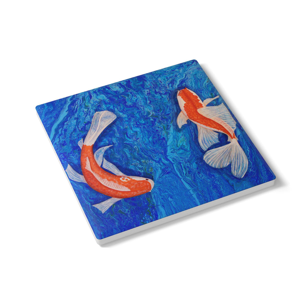 Coaster with koi fish design on a blue watercolor background
