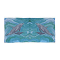 Towel/blanket with dolphins design on a blue and green abstract background