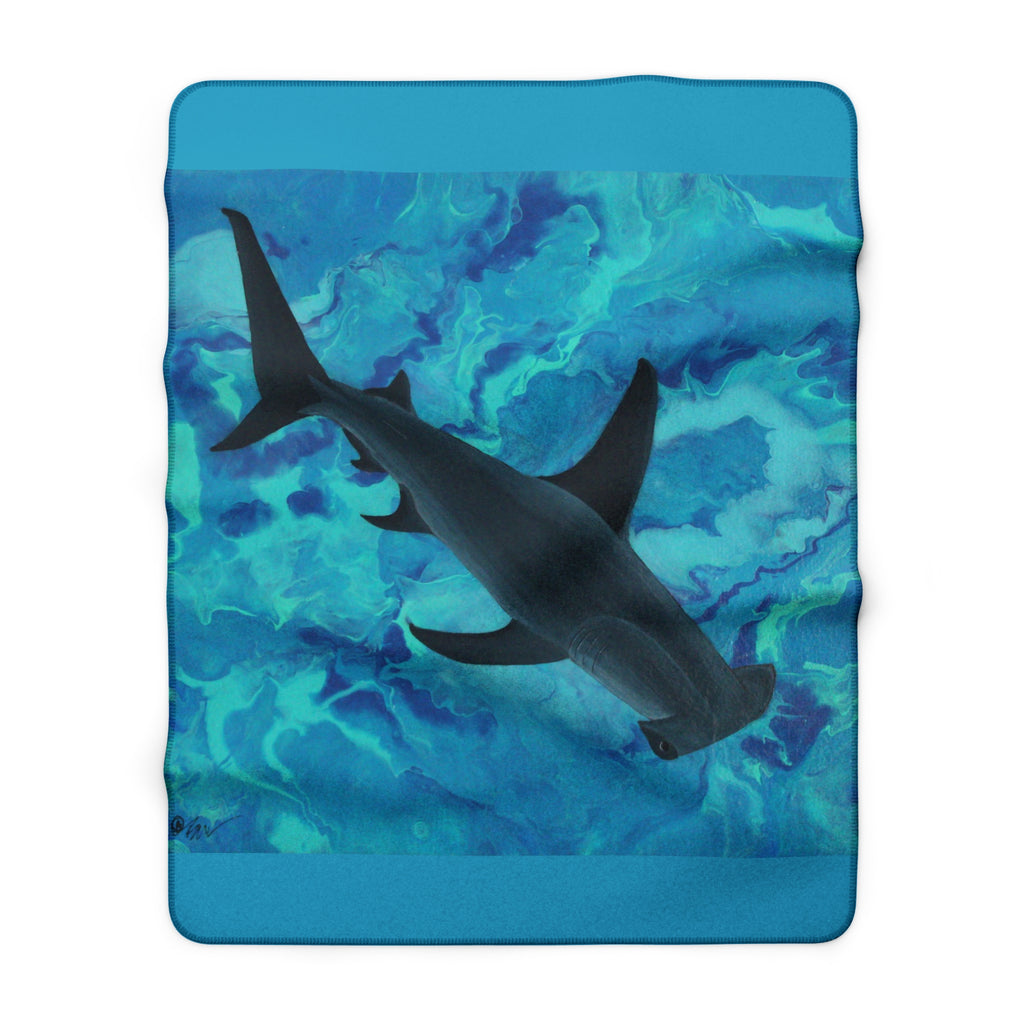 Blanket with a shark design on a blue and green abstract pattern