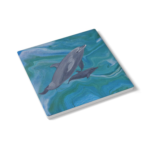 Coaster with dolphin design on a white background