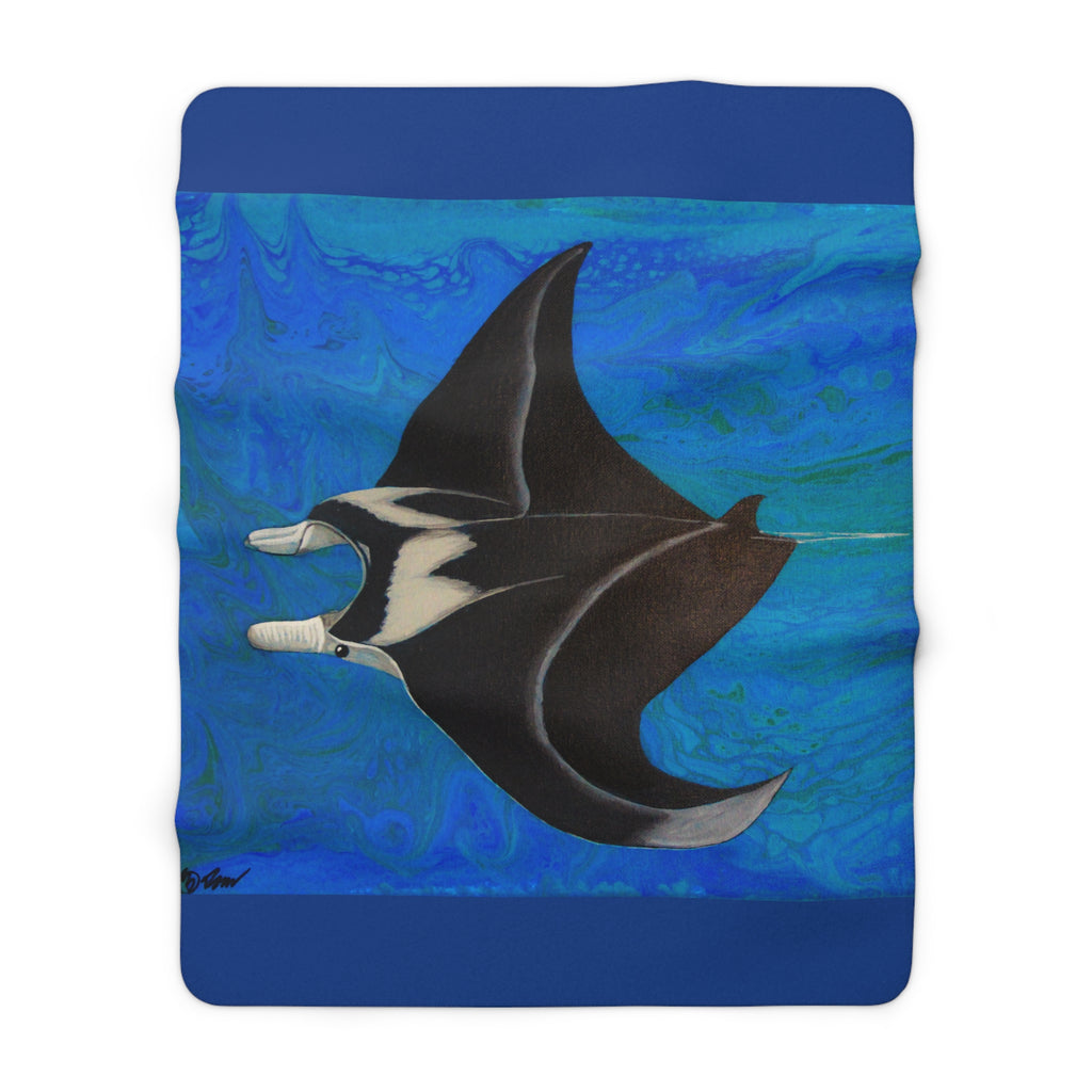 Fleece blanket with a manta ray design on a blue background