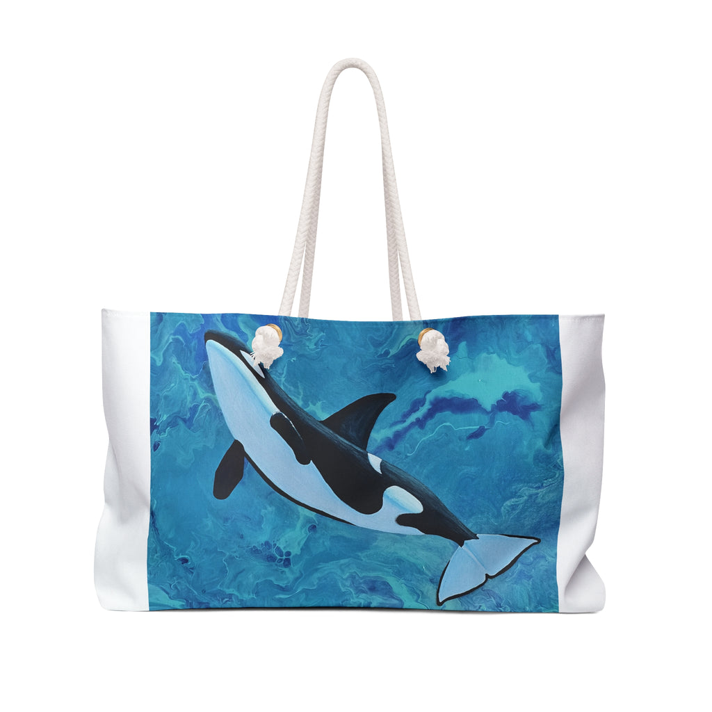 Tote bag with an orca whale design on a blue watercolor background