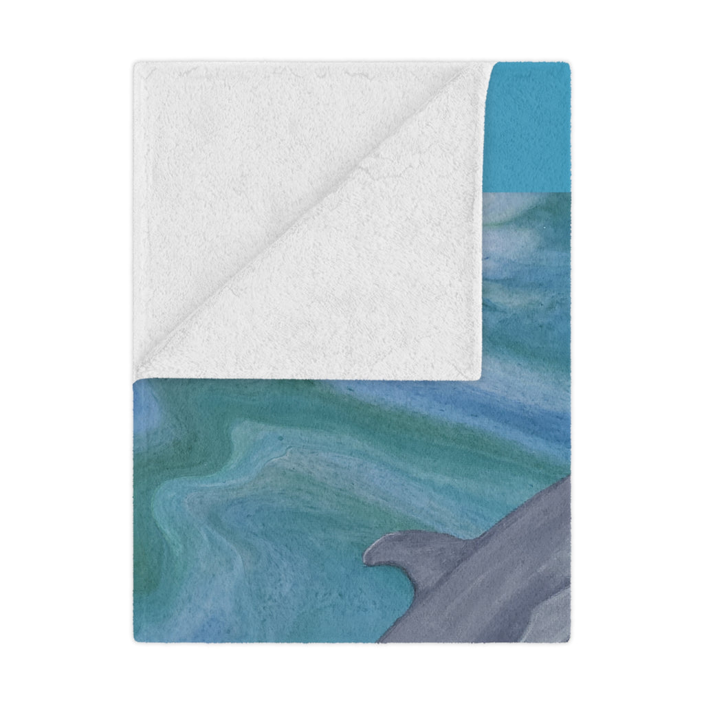 Blanket with whale design and textured border on a white background