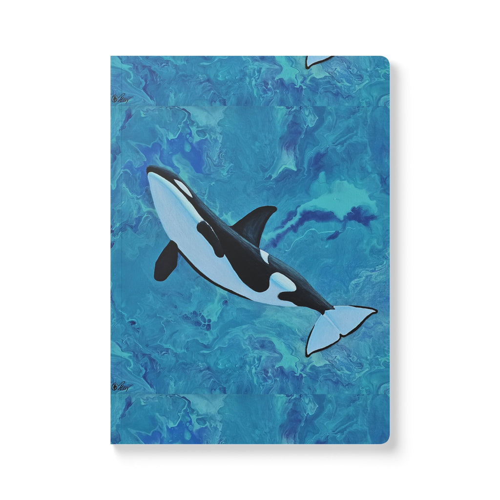 Notebook with an orca whale design on a blue watercolor background