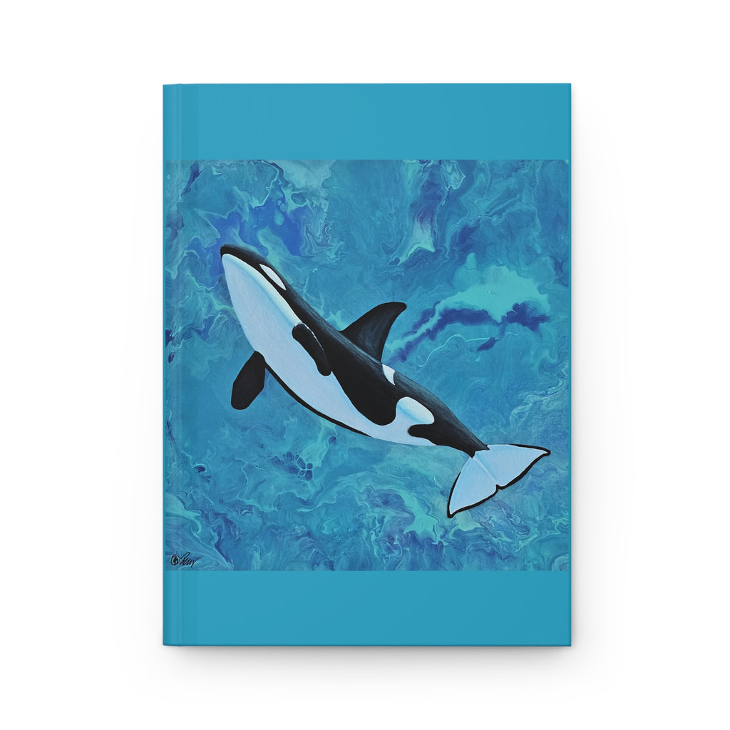 Notebook with an orca whale illustration on a blue watercolor background
