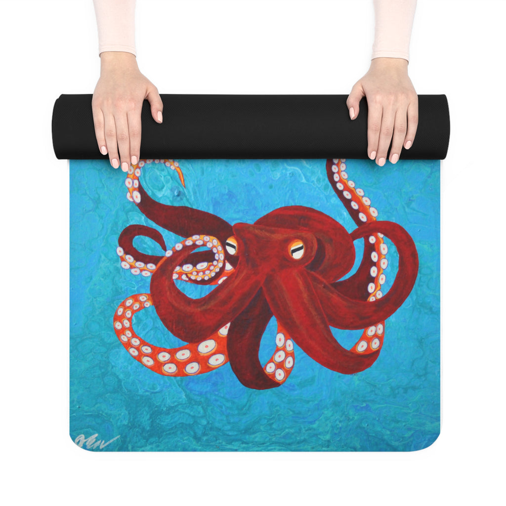 Yoga mat with red octopus design held by a person