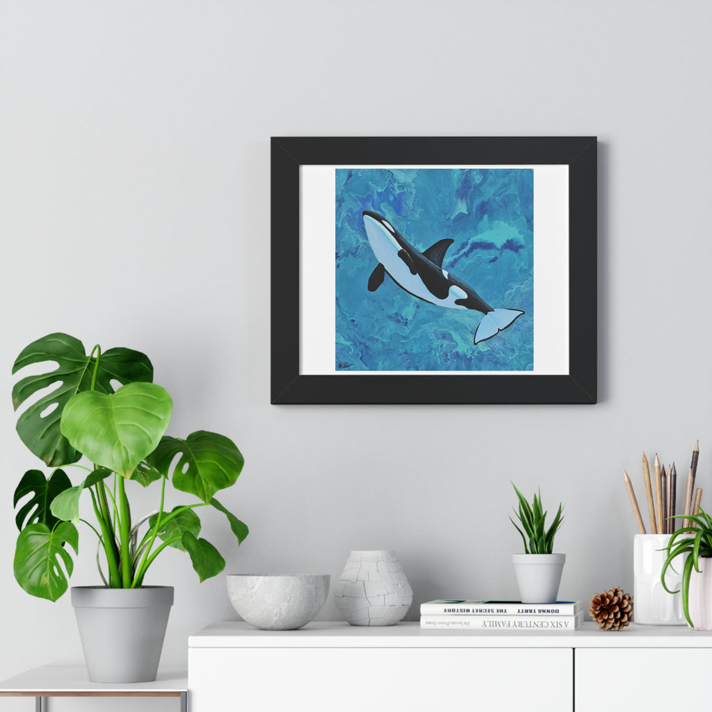 Framed artwork of an orca whale on a wall above a white cabinet with decorative items.
