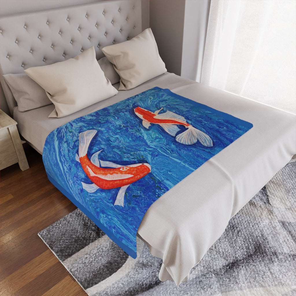 Bed with a decorative blanket featuring koi fish design