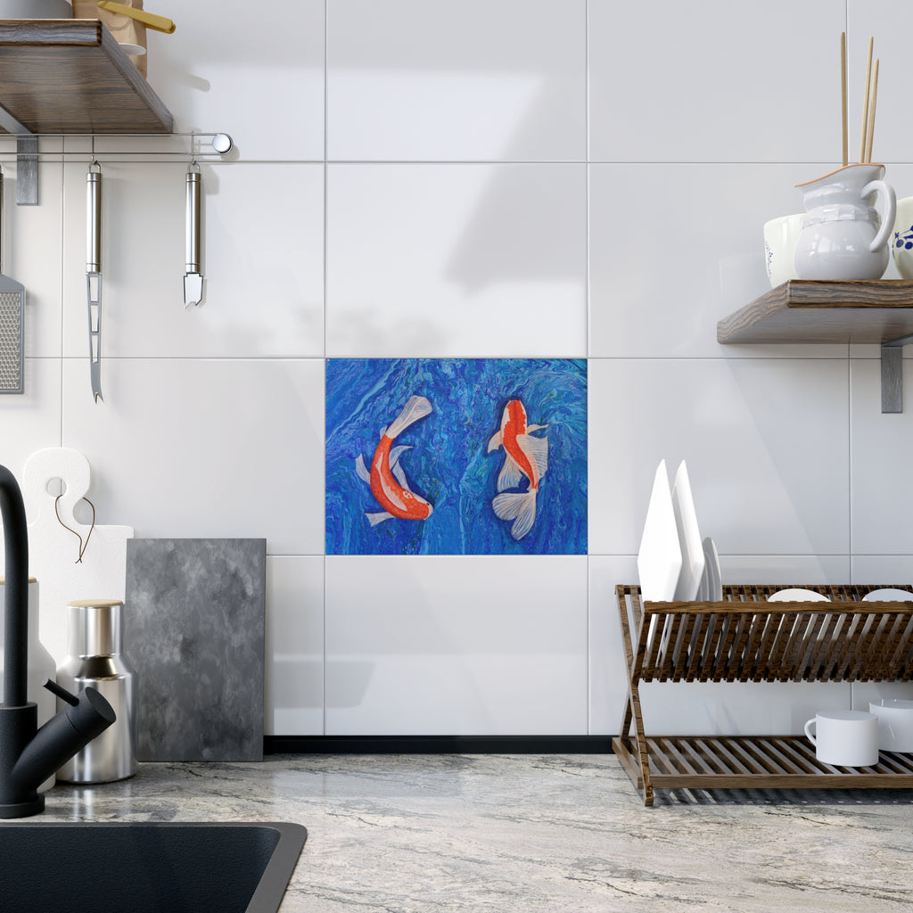 Modern kitchen with a decorative tile featuring two fish on a white tiled wall.