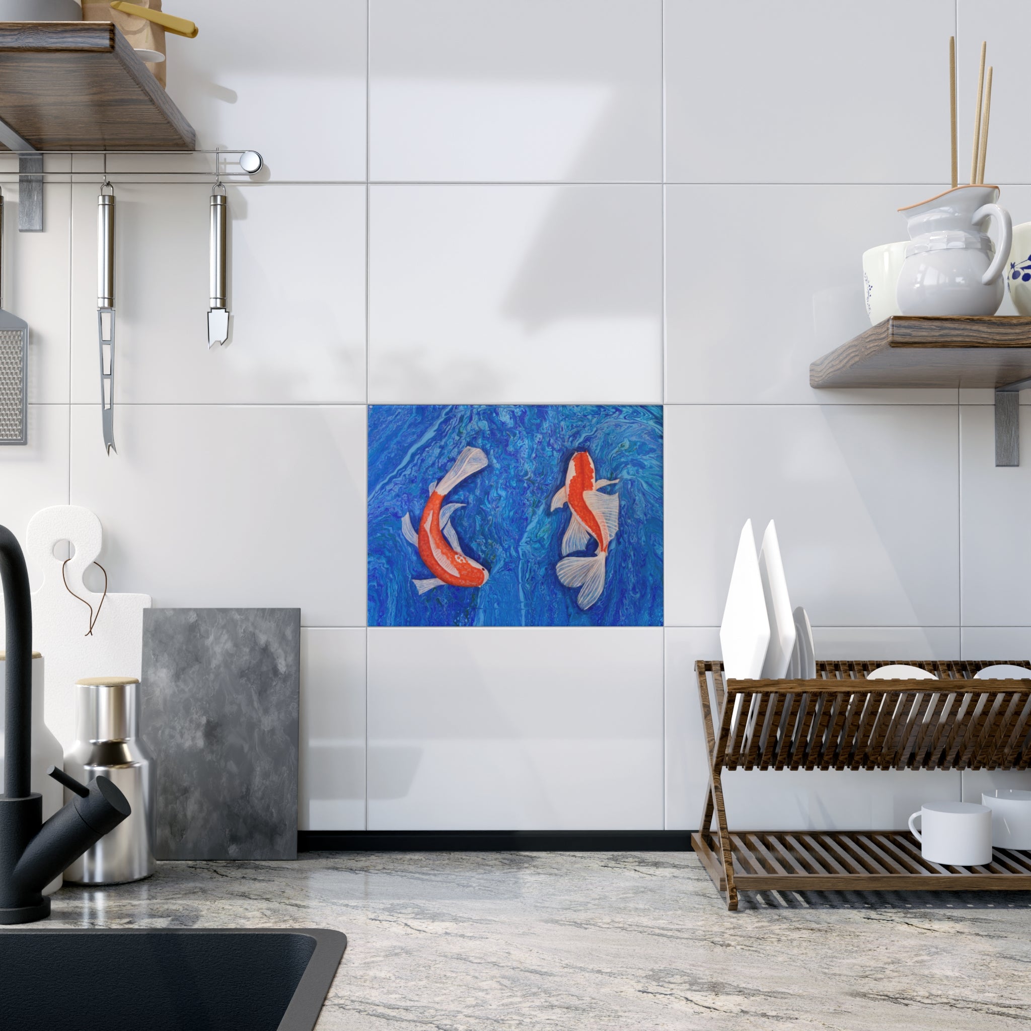 Modern kitchen with a decorative tile featuring two fish on a white tiled wall.