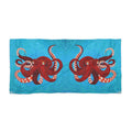 Towel/blanket with red octopus design on a blue background