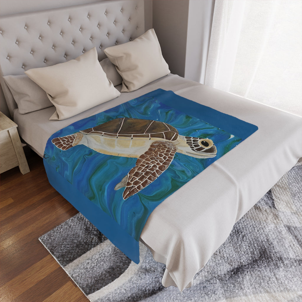Bed with a turtle-themed blanket draped over it in a bedroom setting.