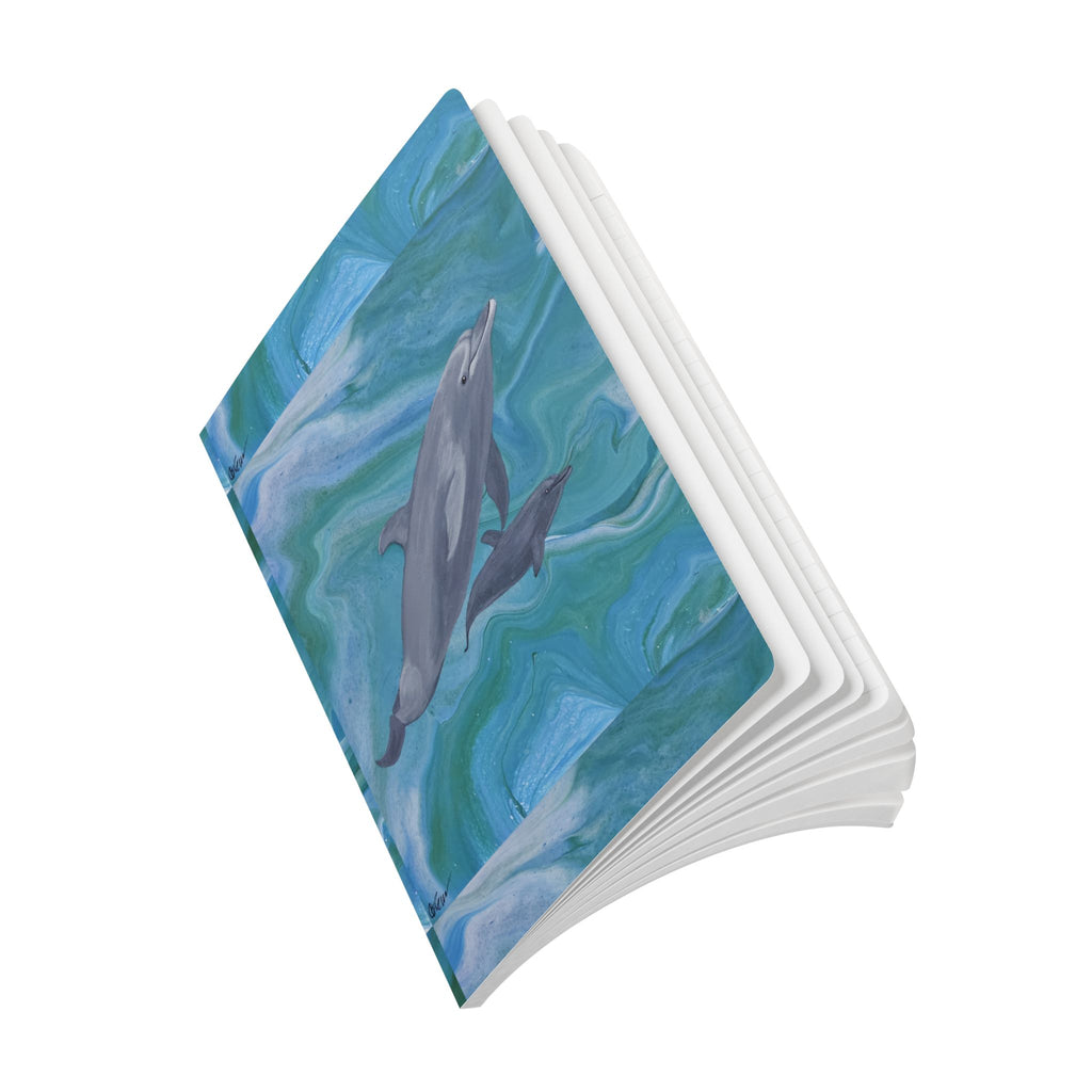 Notebook with dolphin illustration on a white background