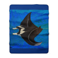 Fleece blanket with manta ray design on a blue background