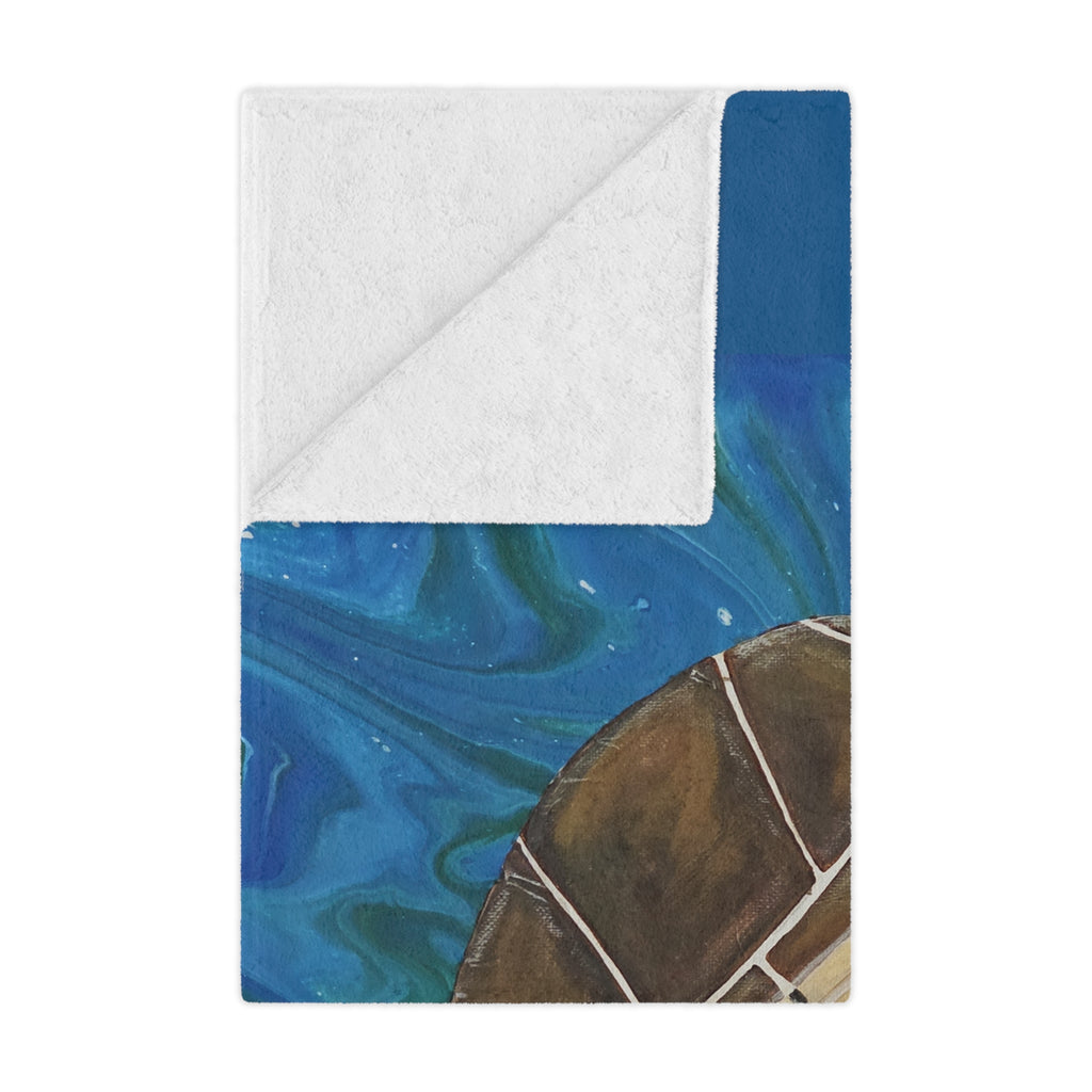 Blanket folded with blue and brown abstract design on a white background