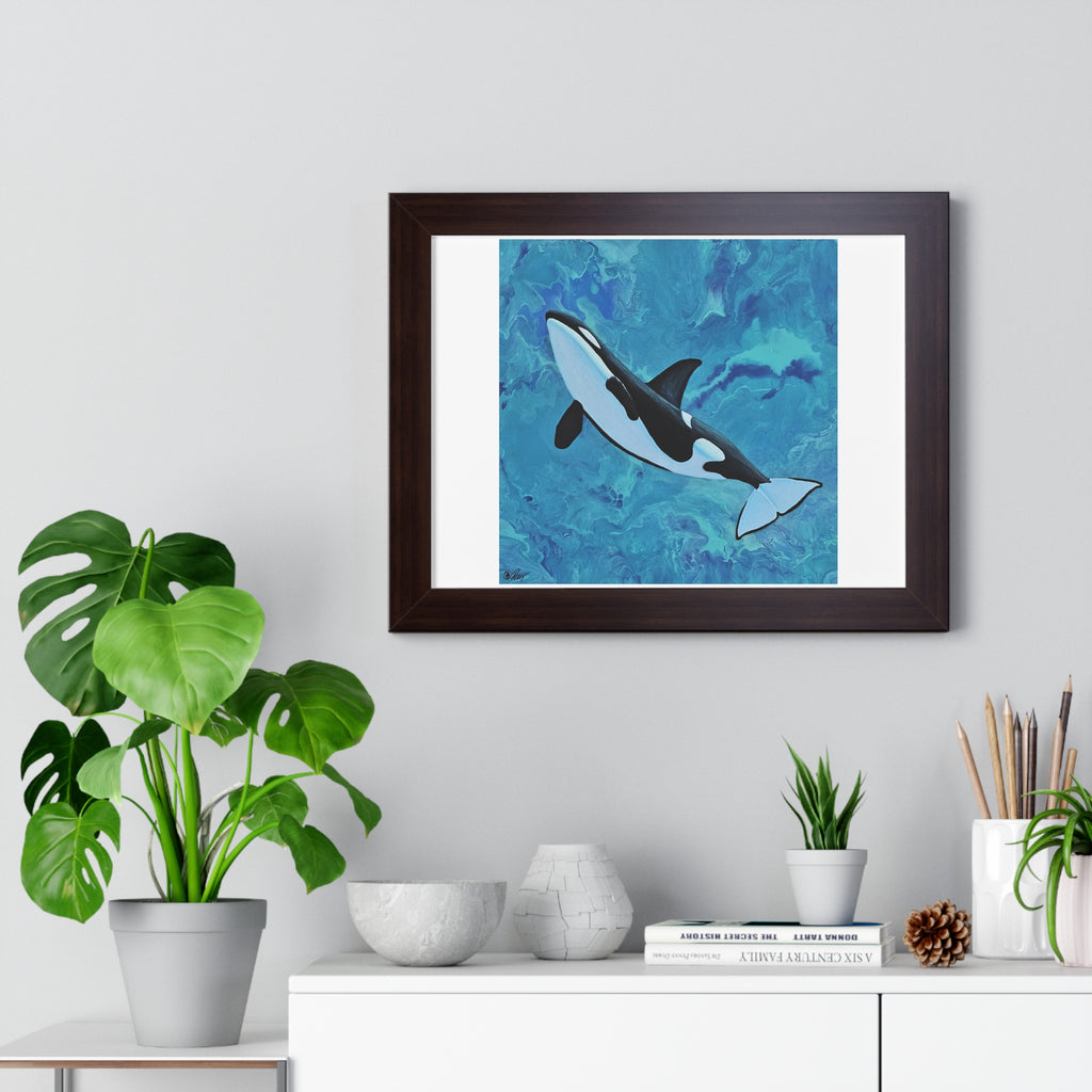 Framed artwork of an orca whale on a wall above a white cabinet with decorative items.