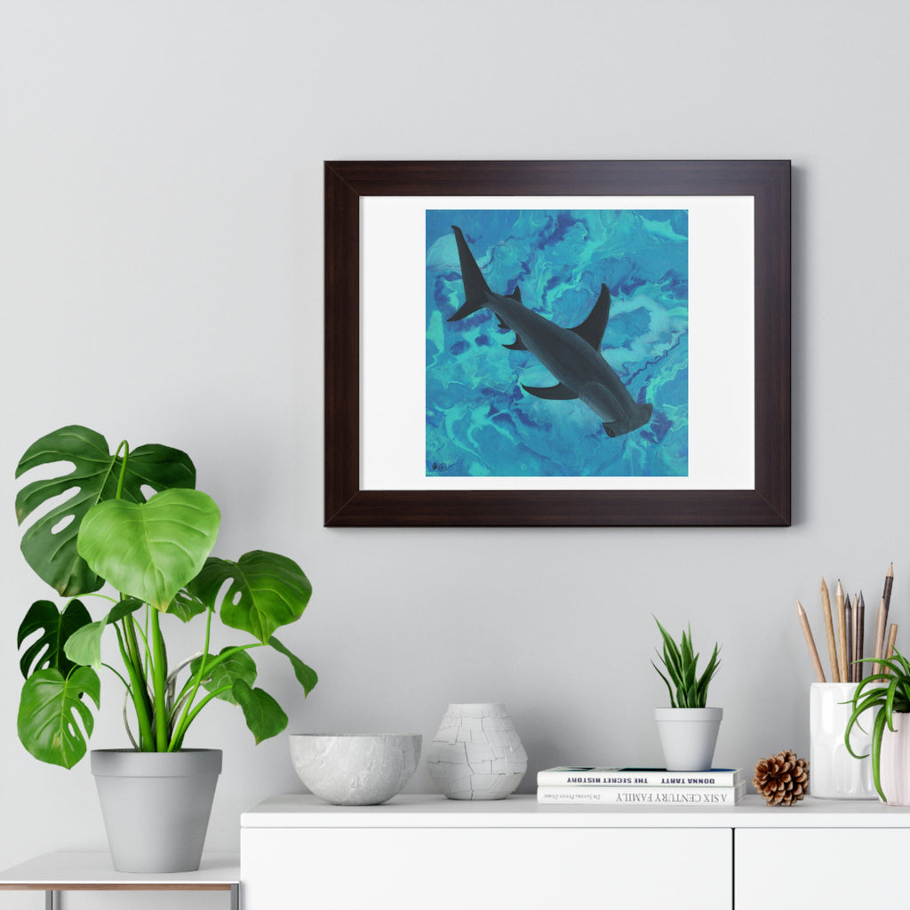 Framed artwork of a shark on a wall above a white cabinet with decorative items.