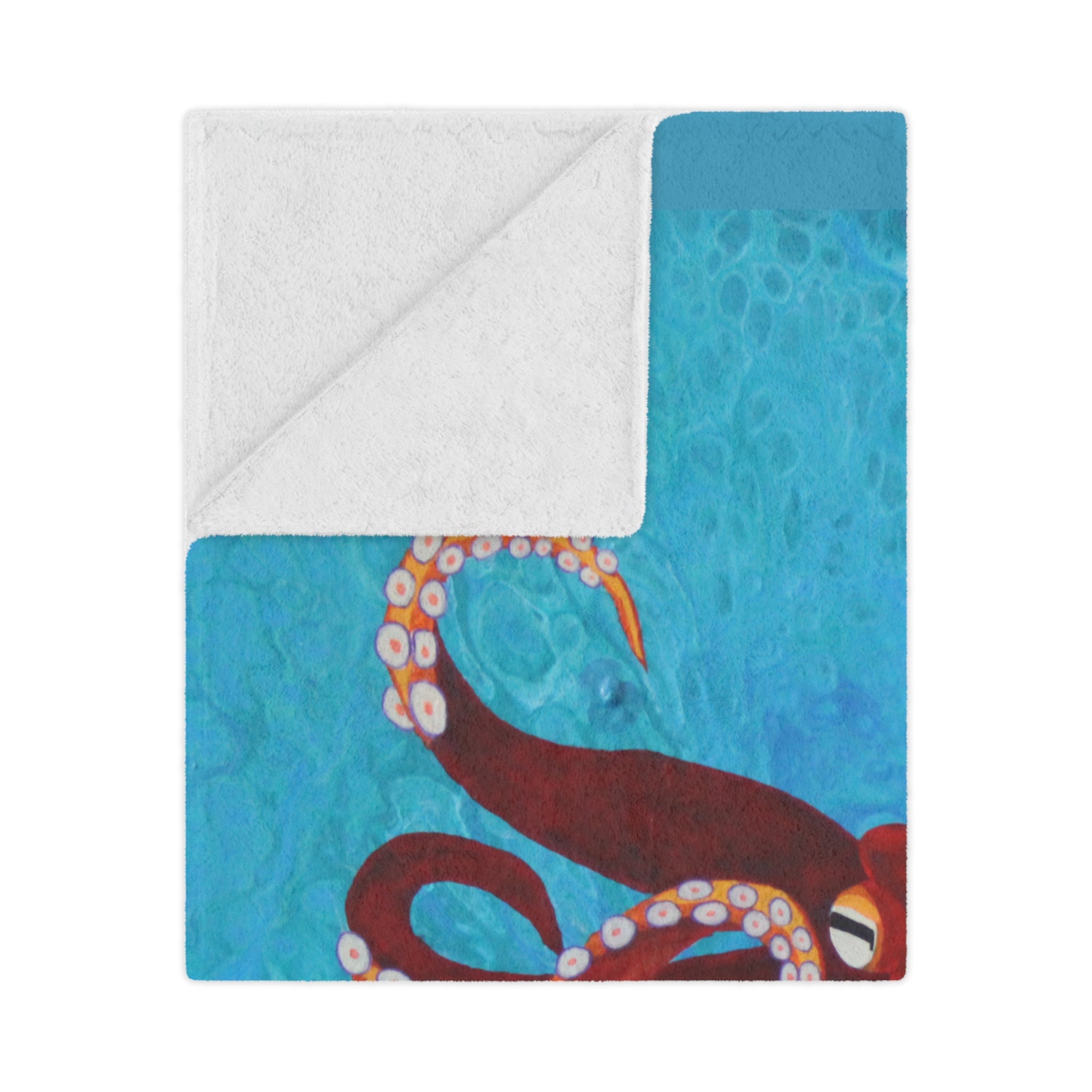 Blanket folded with octopus design on a blue and white background