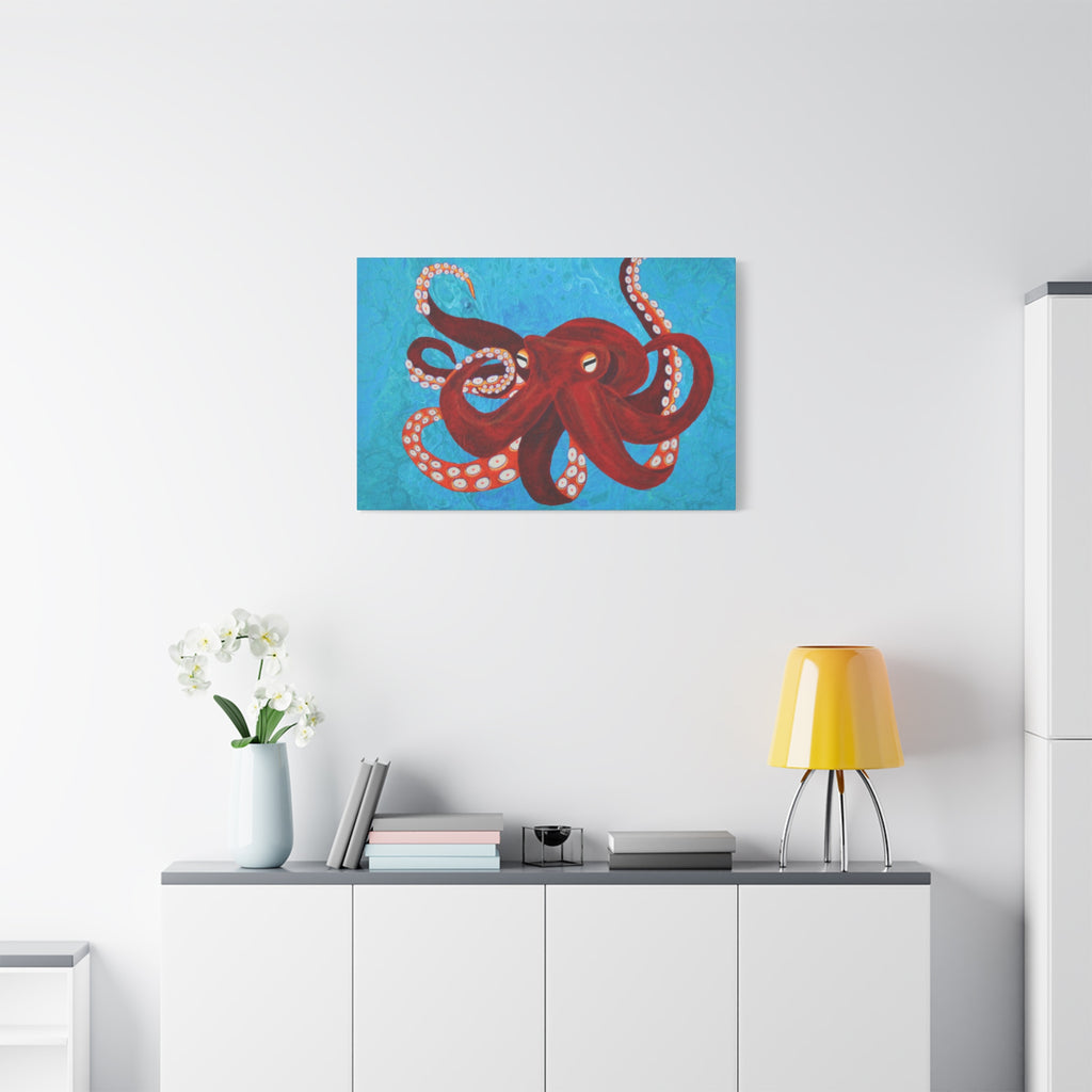 Red octopus painting on a white wall above a white cabinet with a yellow lamp and white flowers.