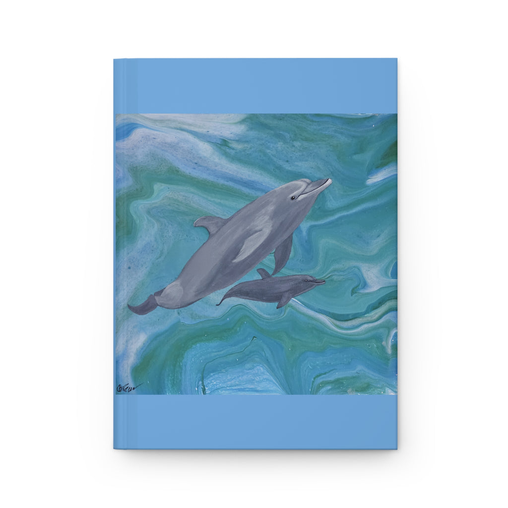 Notebook cover with dolphins on a blue and green marbled background