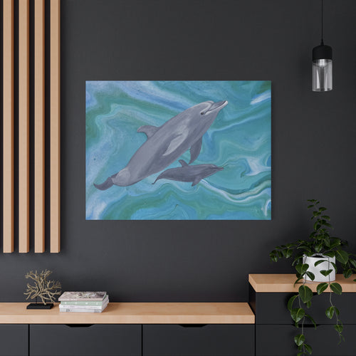 Framed artwork of two dolphins on a dark wall above a wooden console table.