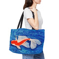 Person carrying a tote bag with a fish design on a white background