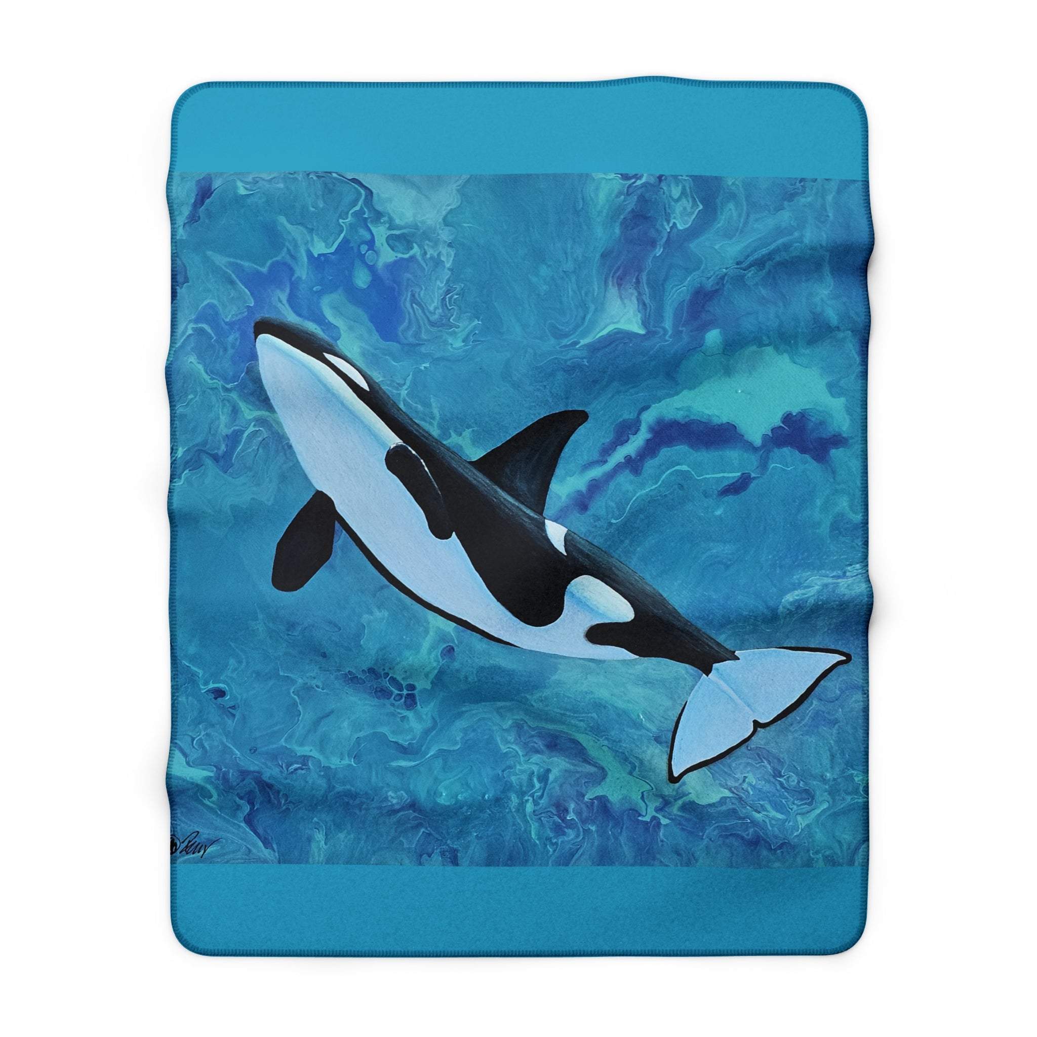 Blanket with an orca whale design on a blue background