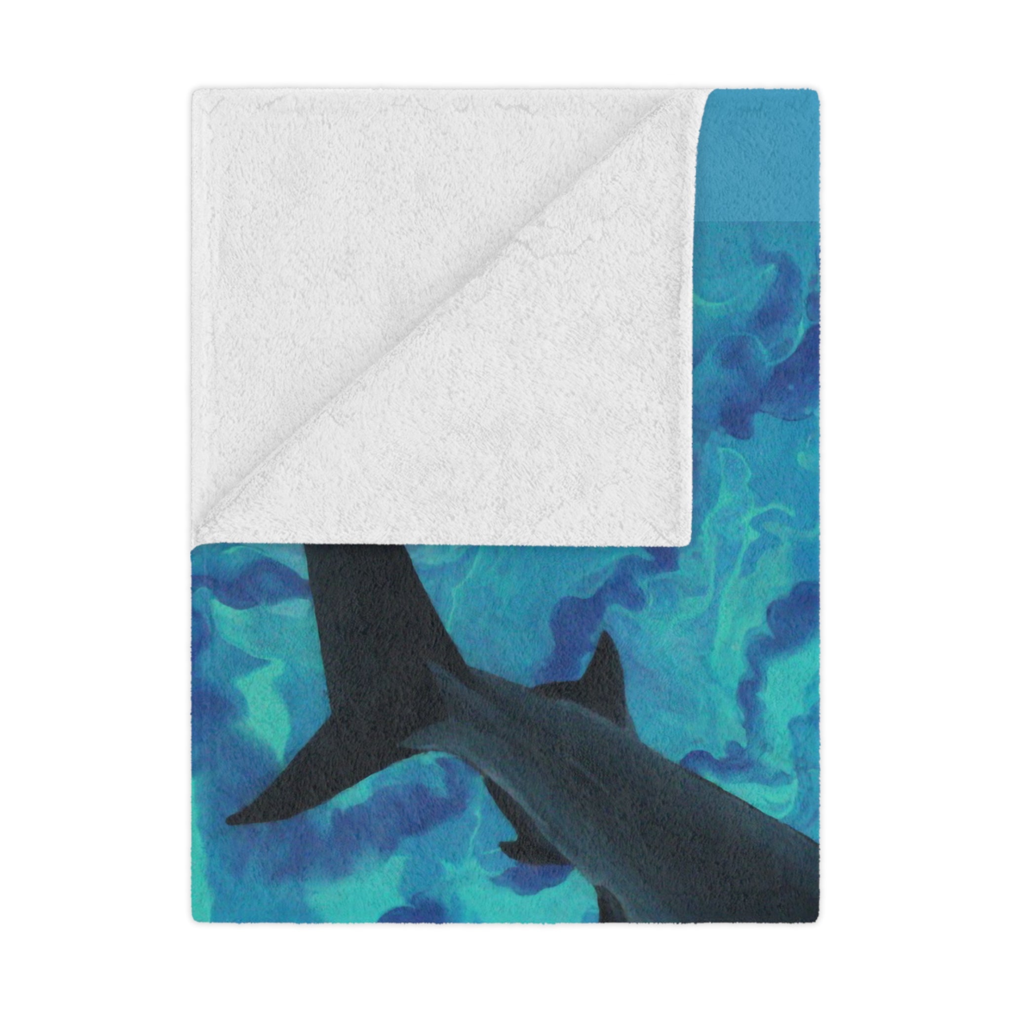 Blanket with shark design on a blue and green patterned background