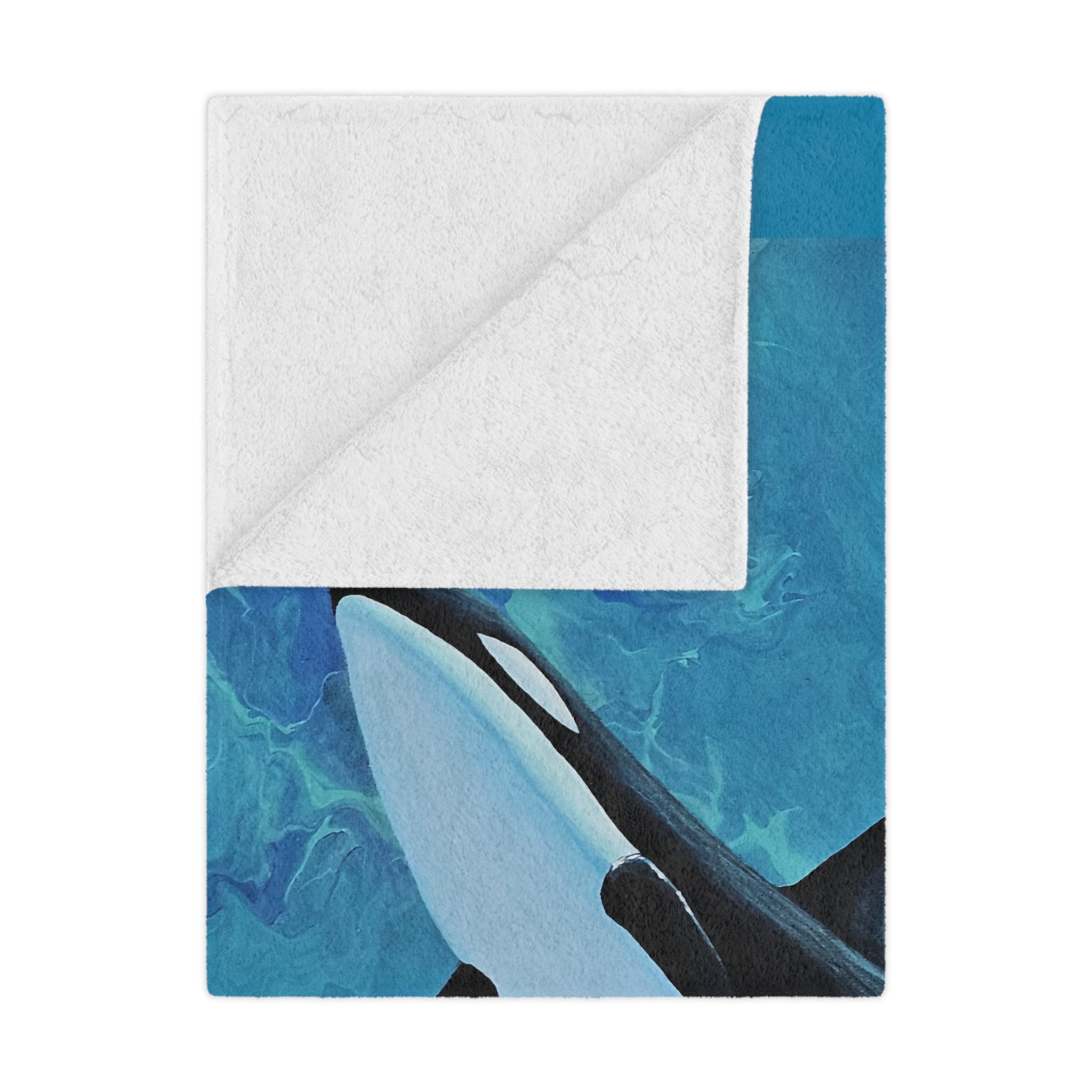 Orca whale design on a blue and white blanket folded