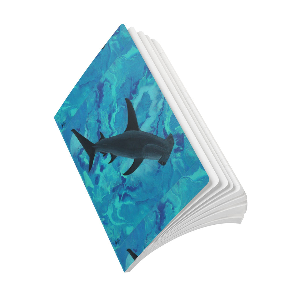 Open Notebook with a shark design on a blue watercolor background