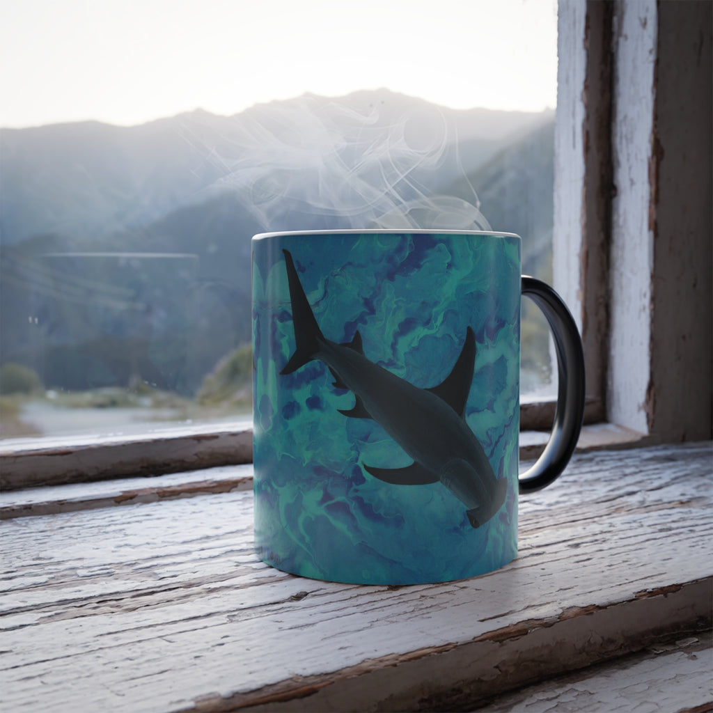 Mug with shark design on a windowsill with a mountain view