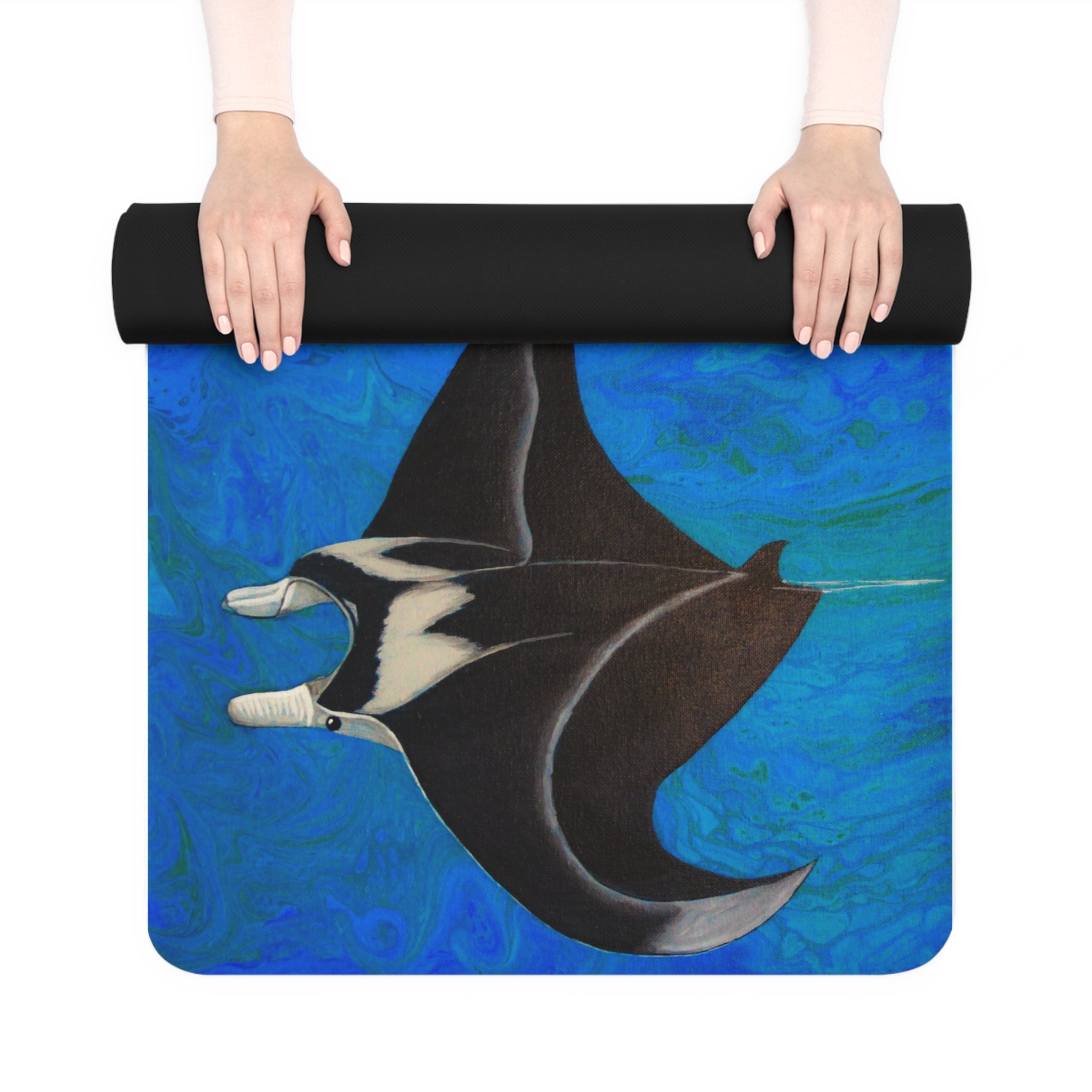 Yoga mat with manta ray design held by a person