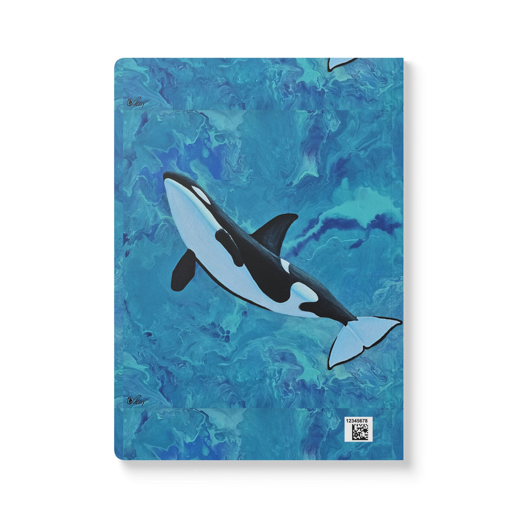 Notebook with an orca whale design on a blue watercolor background