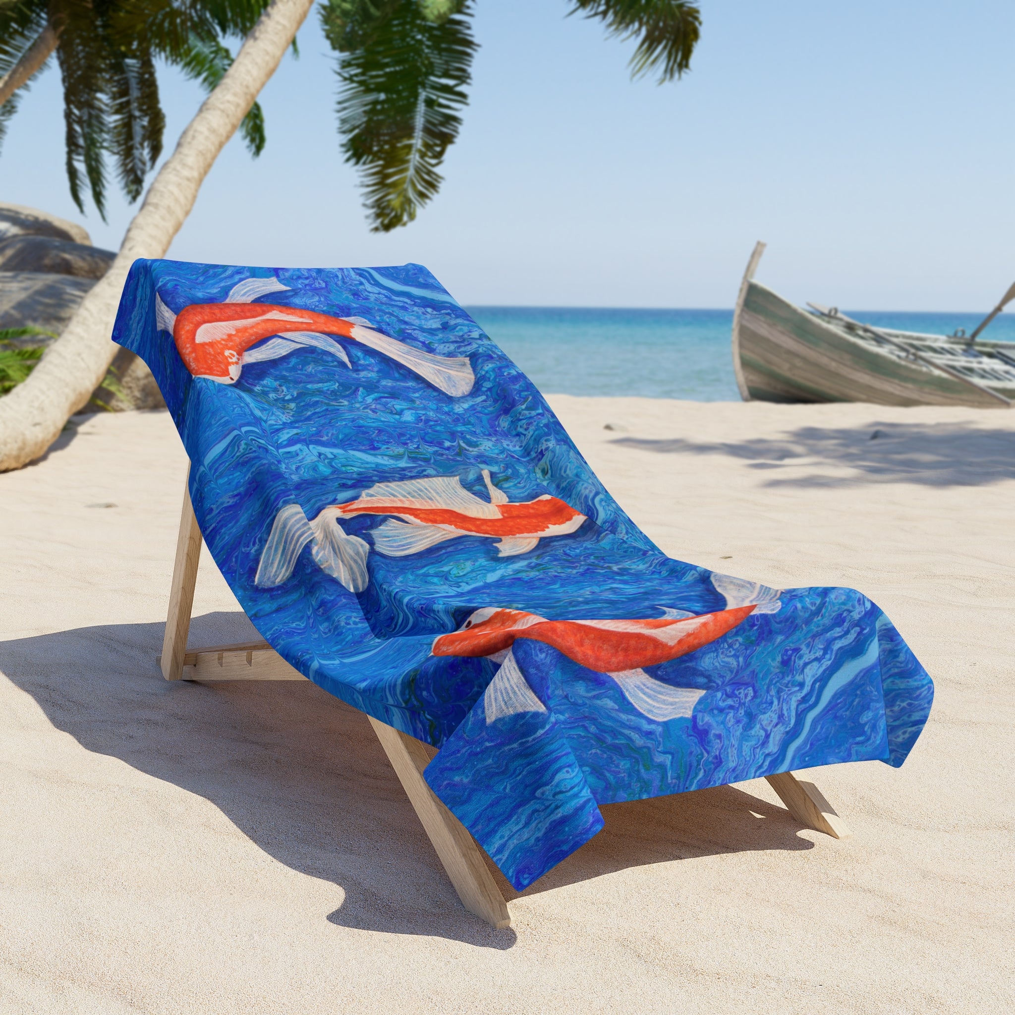 Beach towel/blanket with fish design on a lounge chair at the beach