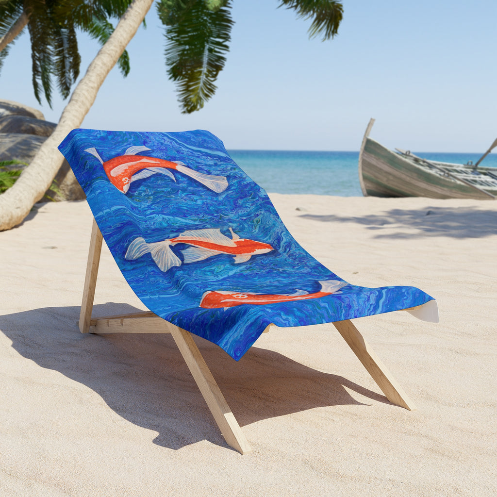 Beach towel/blanket with fish design on a wooden chair at the beach