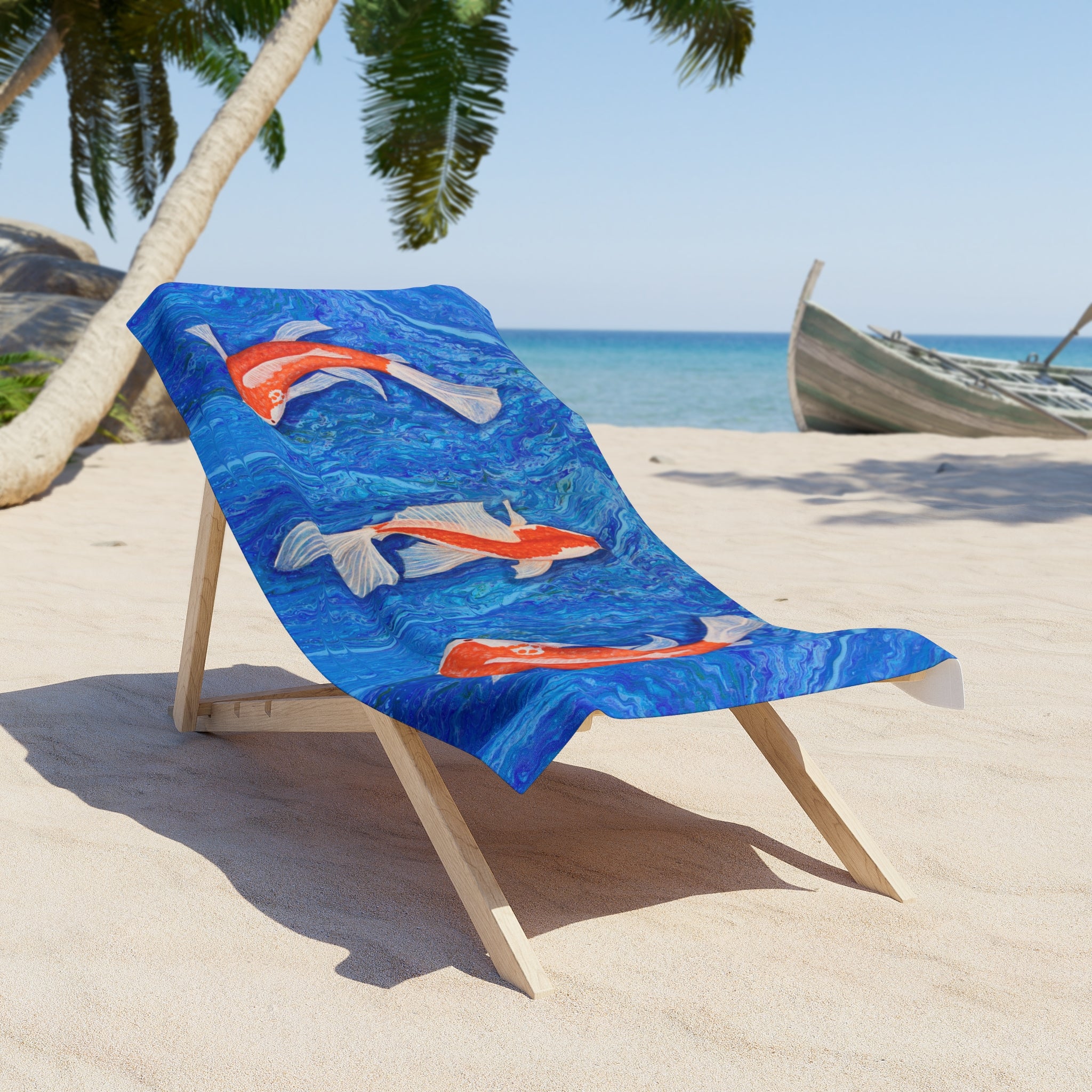 Beach towel/blanket with fish design on a wooden chair at the beach