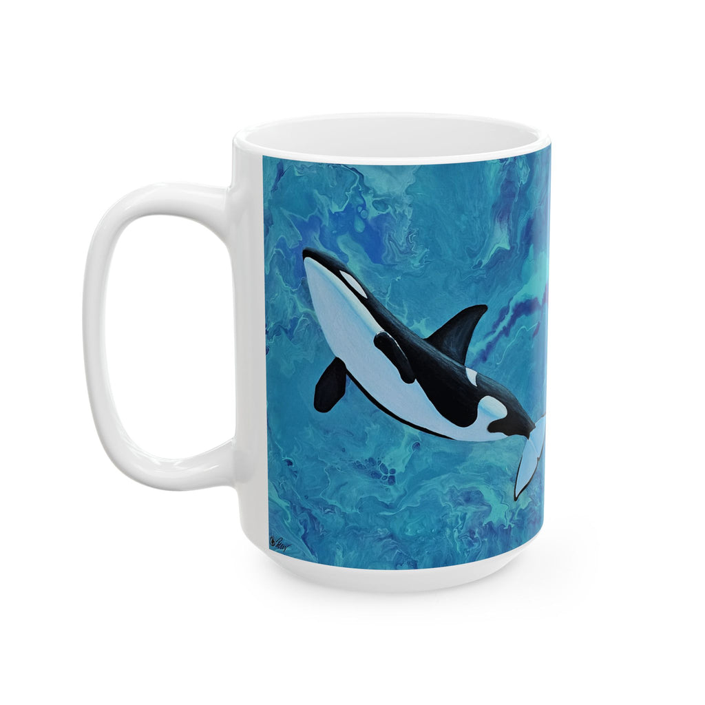 White mug with an orca whale design on a blue watercolor background