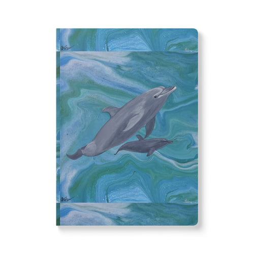Notebook with a dolphin illustration on a blue and green abstract background