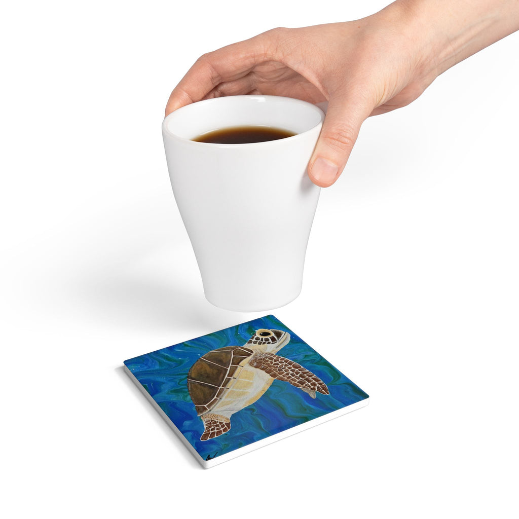 Coaster with turtle design under a white cup of coffee