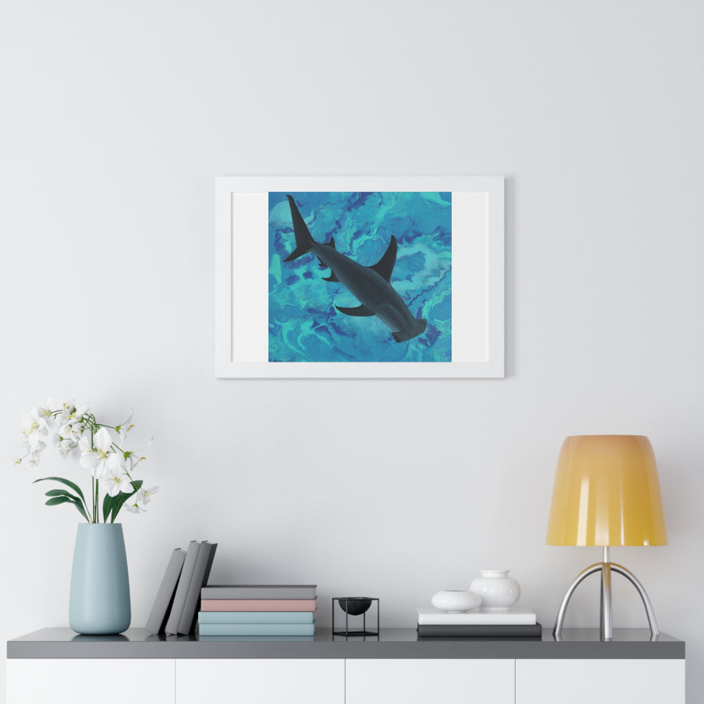 Framed artwork of a shark in water on a wall above a shelf with decor items.